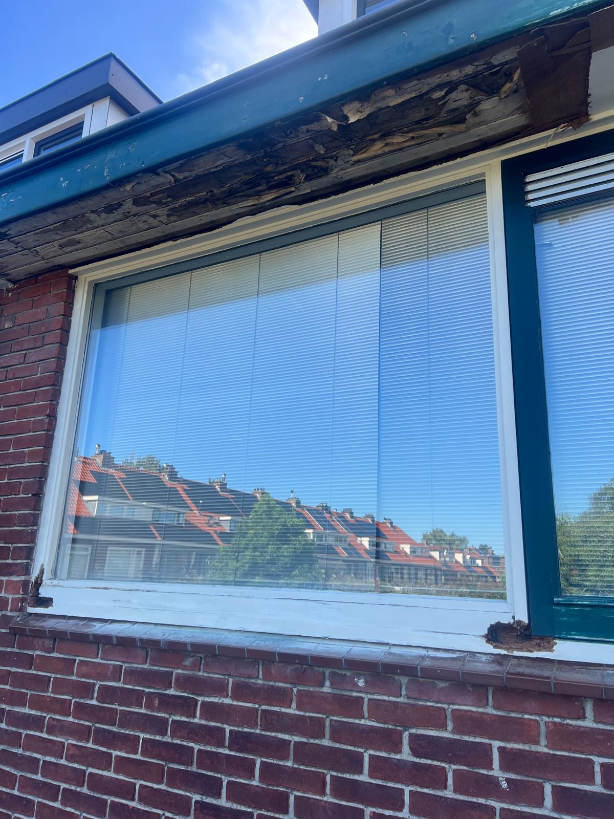 Kozijn met houtrot en losgelaten verf vóór de reparatie